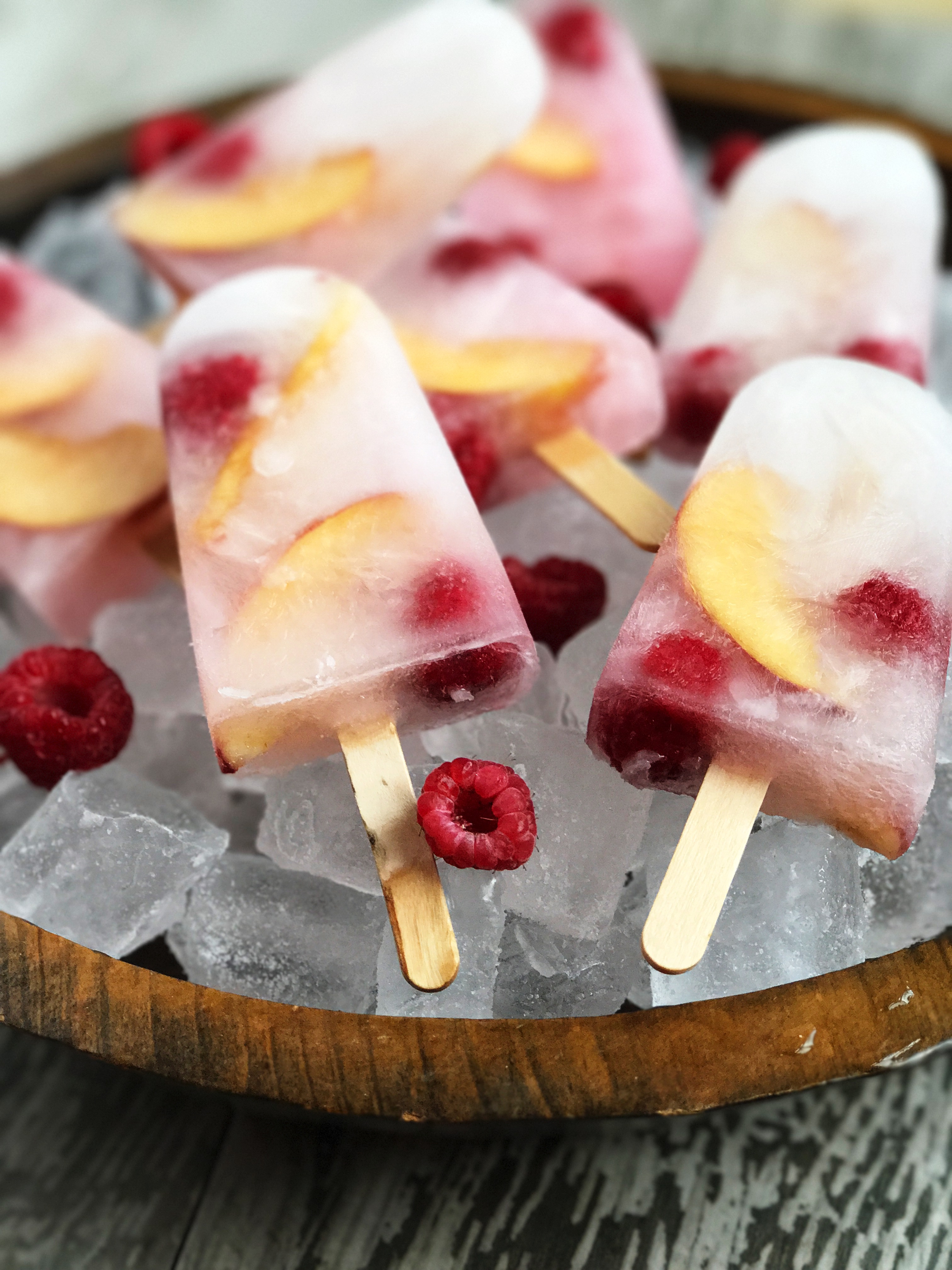 Peach Schnapps Popsicles with Frozen Raspberries