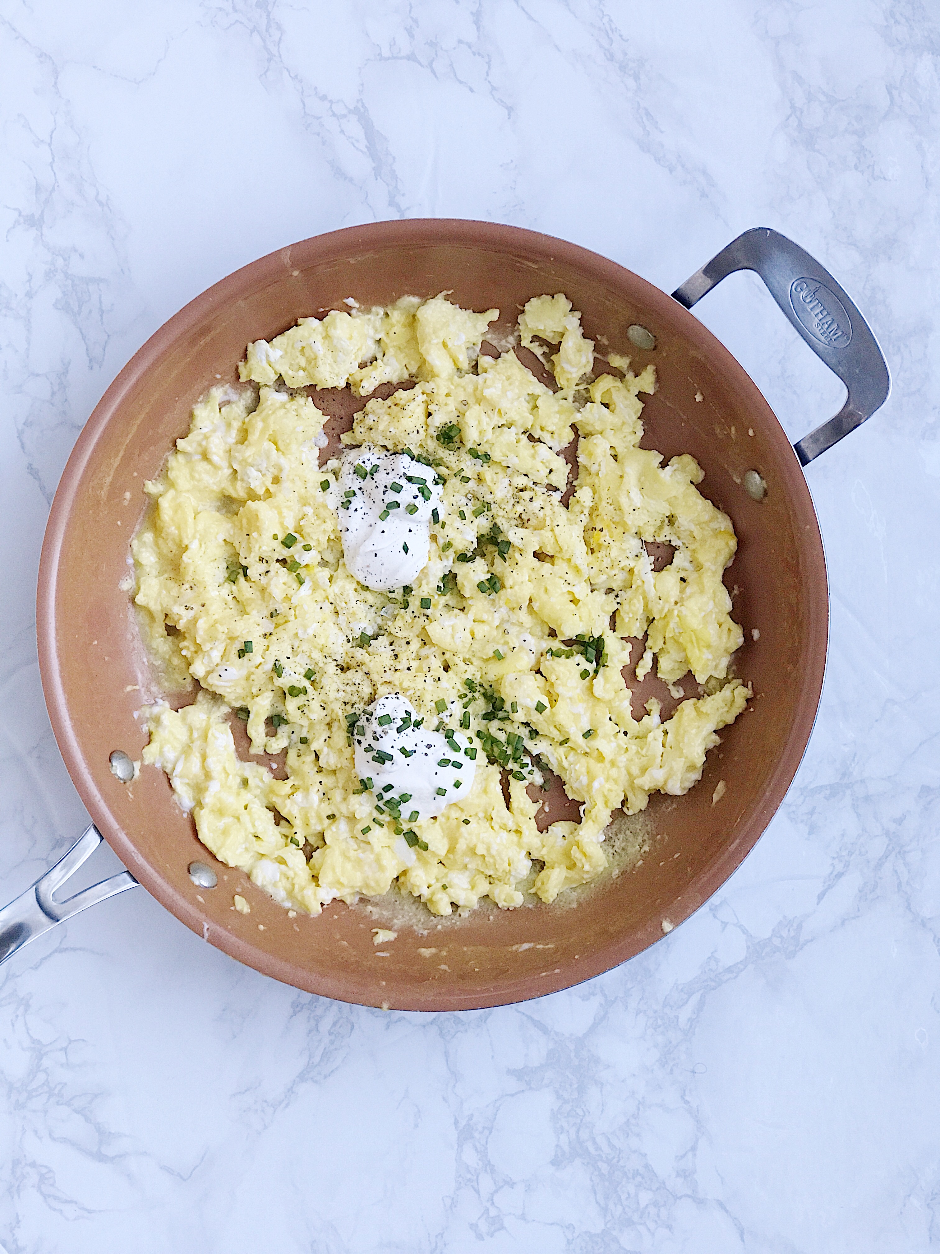 A bowl full of eggs made from this scrambled eggs recipe using creme fraiche