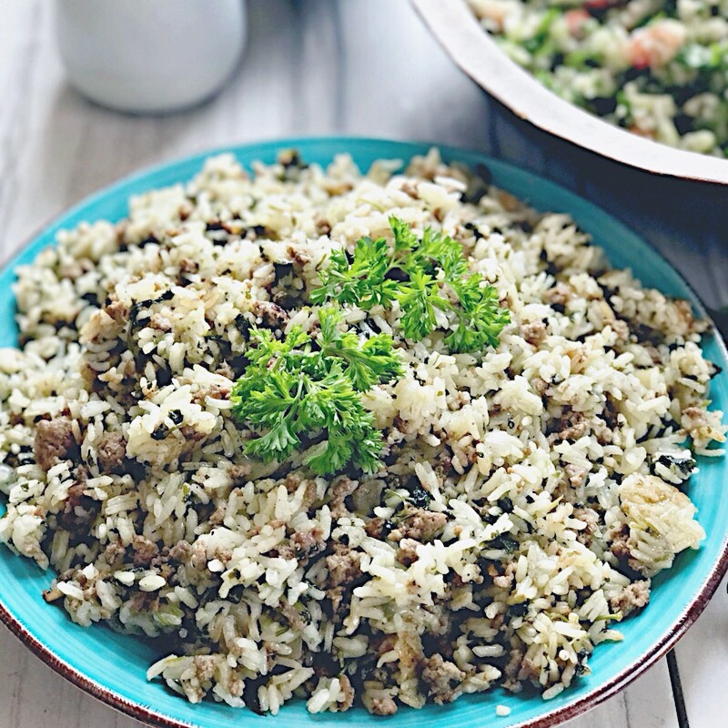 Israeli lamb rice, displayed in a light blue dish, and finished with a touch of parsley.